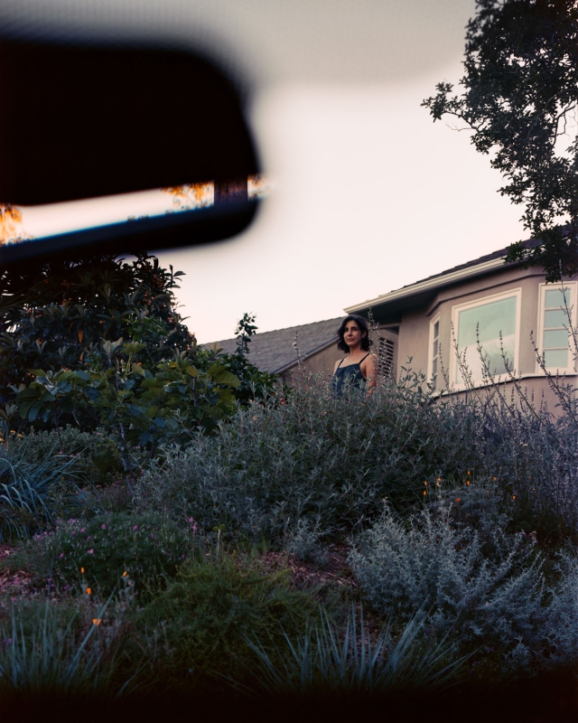 Woman standing in the midground, surrounded by lavender bushes